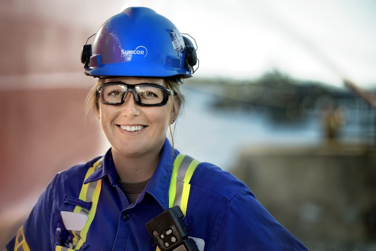 The covers of the 2023 Report on Sustainability. The Report on Sustainability cover features a person in a blue hardhat, safety glasses and blue coveralls smiling at the camera