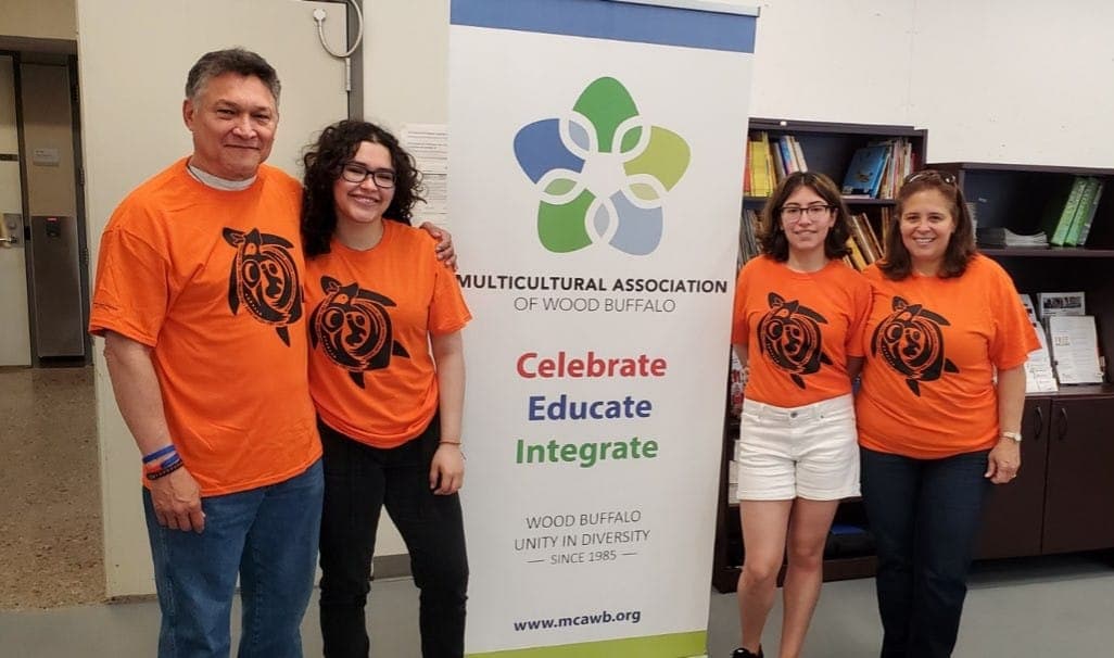 Hiliany Ocando, pictured with her family wearing her Orange Shirt Day Design.
