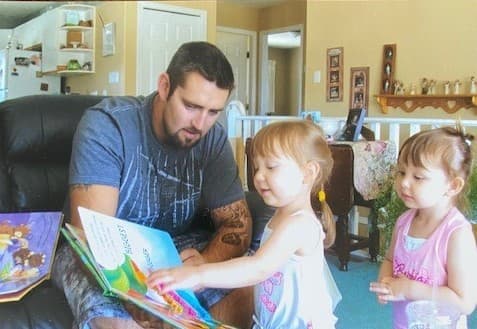Jeffrey reads to his nieces, who are Indigenous, when they were younger