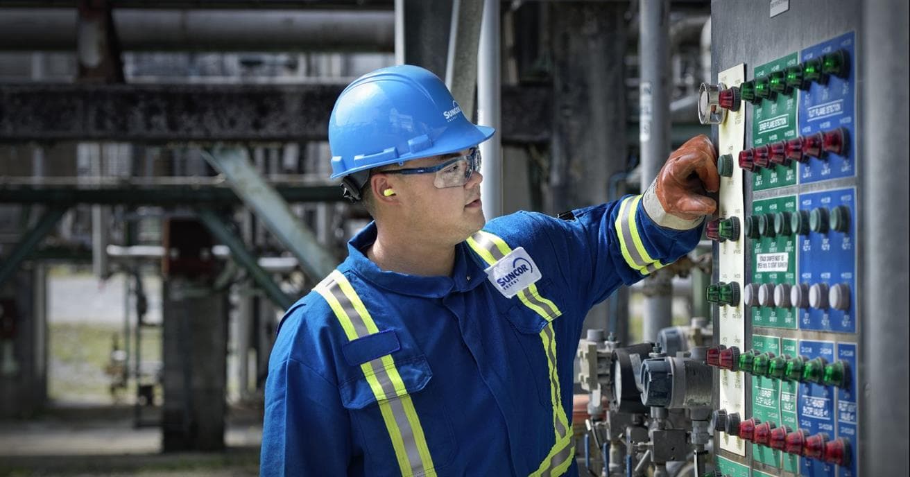Suncor essential worker operating a plant