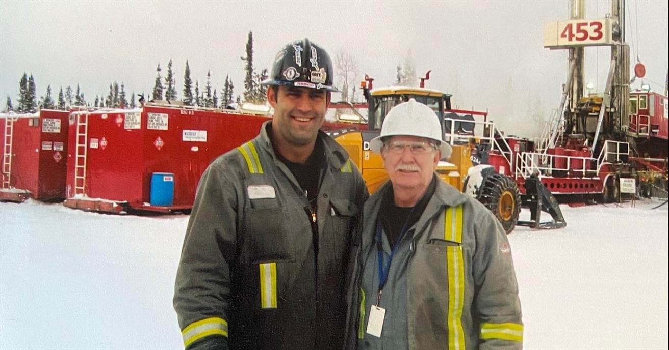 two men in personal protective equipment standing in front of operations