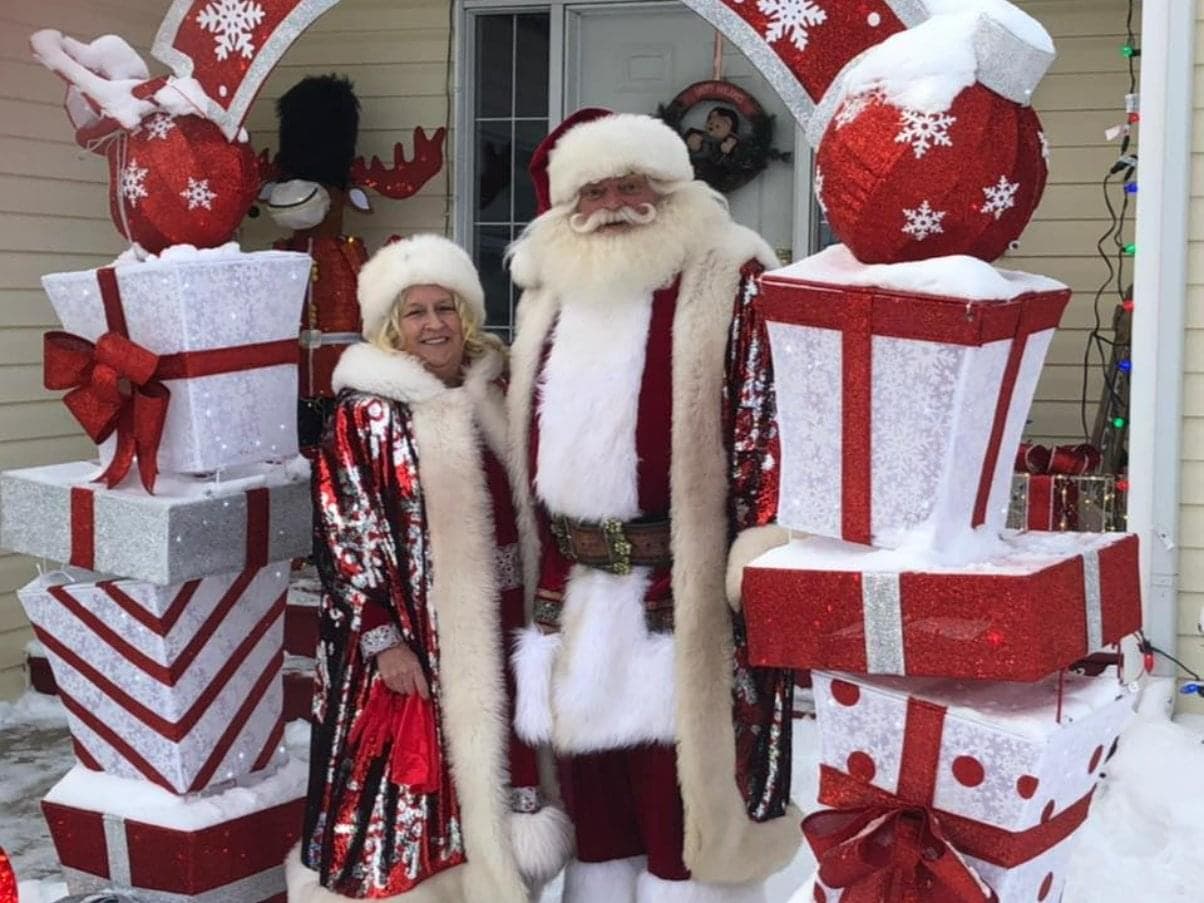 Harry and his wife pose as Santa and Mrs. Claus