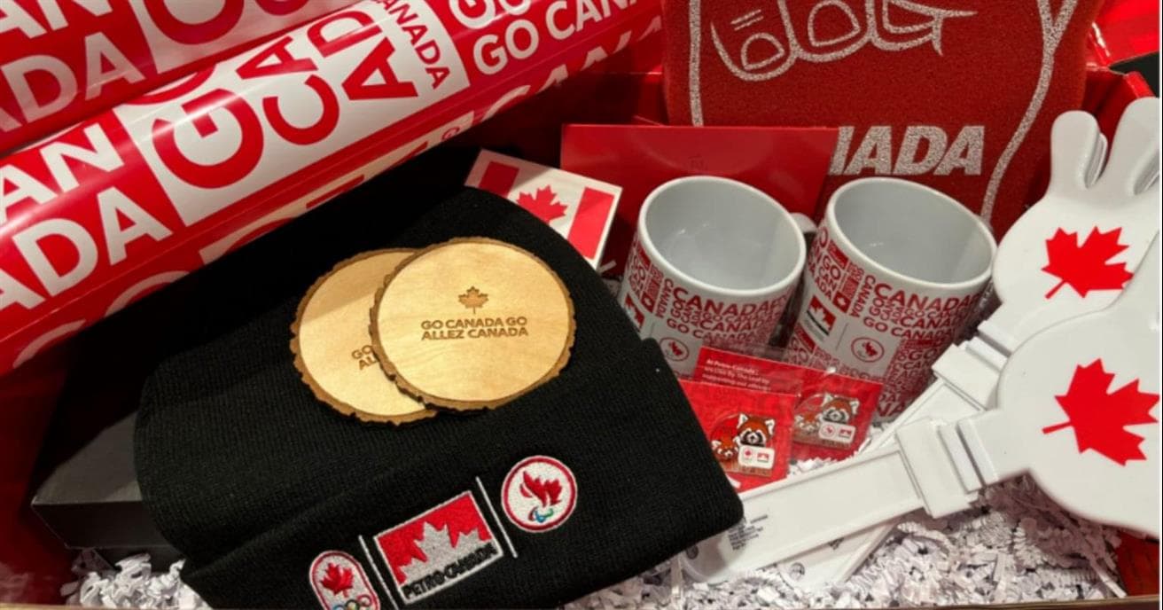 A red box decorated with Team Canada’s logo is filled with fan memorabilia such as a noise makers, a foam finger, drinking glasses, a toque, and much more.