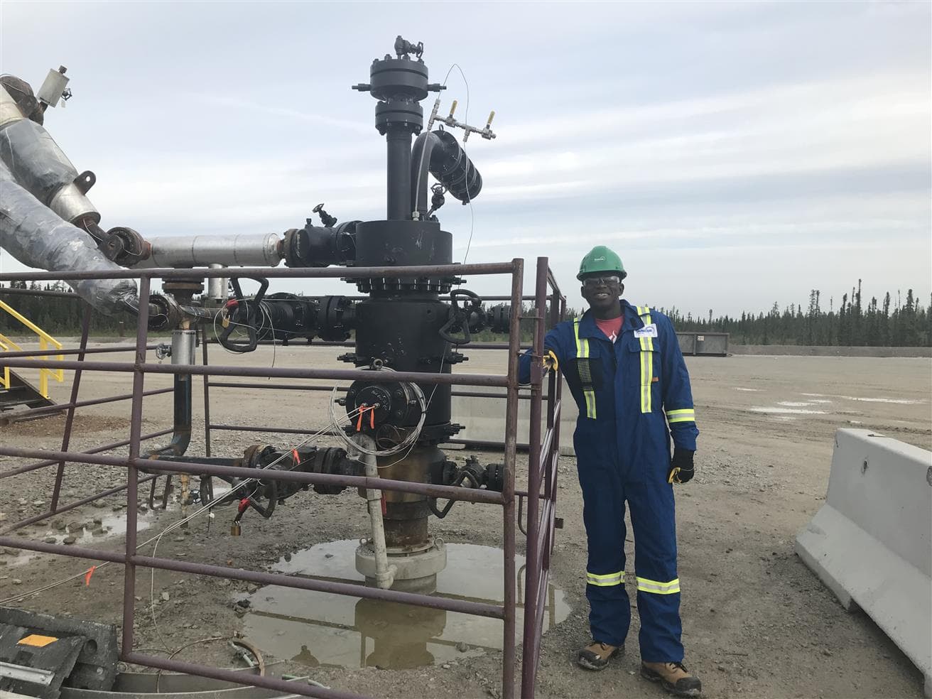 Kome Eto, Upstream production engineer at Suncor, smiles while standing next to a steam assisted gravity drainage (SAGD) well site, at Suncor’s Firebag in situ operations