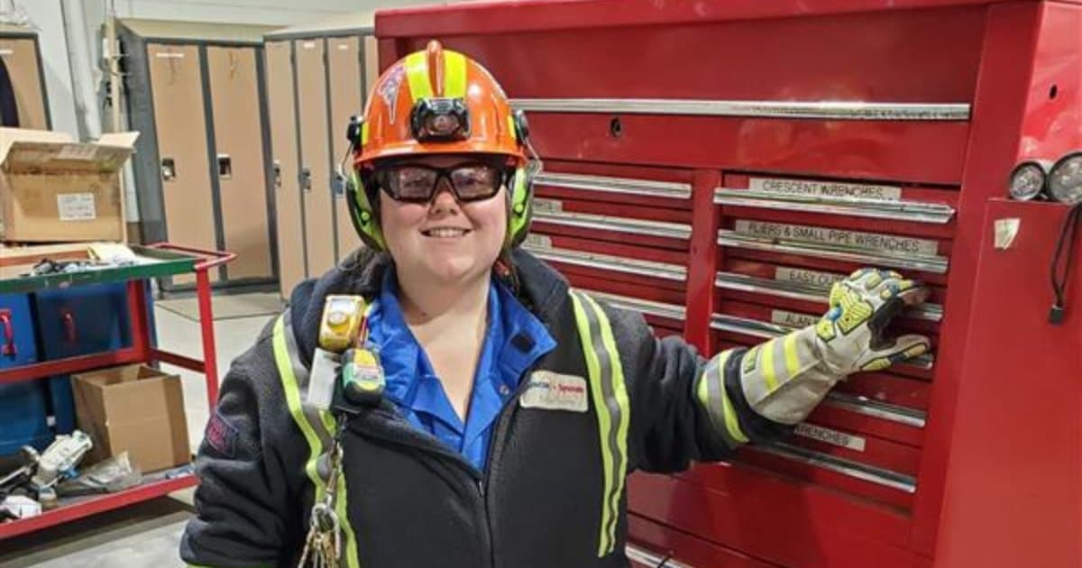Darvi Higdon poses with a tool box at Suncor's Mildred Lake site
